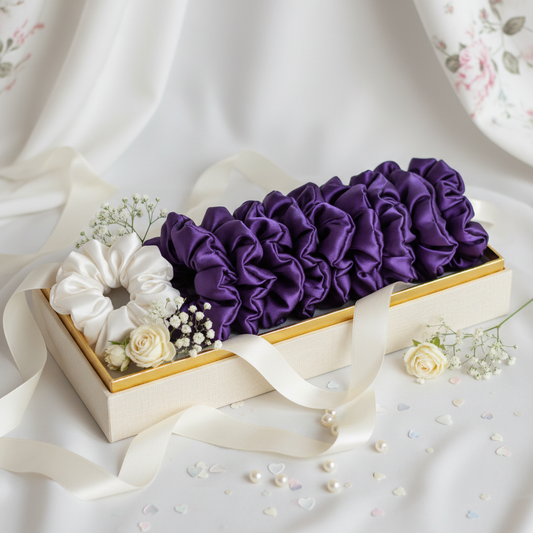 10 purple scrunchies that are all one tone of purple and one white satin scrunchie in a wedding theme